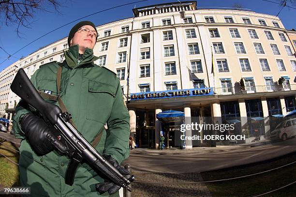 Police officer stands guard in front of the Hotel Bayerischer Hof on February 8, 2008 in Munich, southern Germany, where preparations are under way...