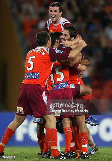 Sasa Ognenovski and Simon Lynch celebrate with team mates after Sasa Ognenovski scores the second goal for the Roar during the A-League minor semi...