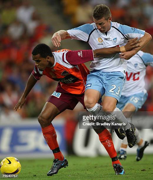 Reinaldo of the Roar attempts to keep defender Ufuk Talay of Sydney at bay during the A-League minor semi final second leg match between the...