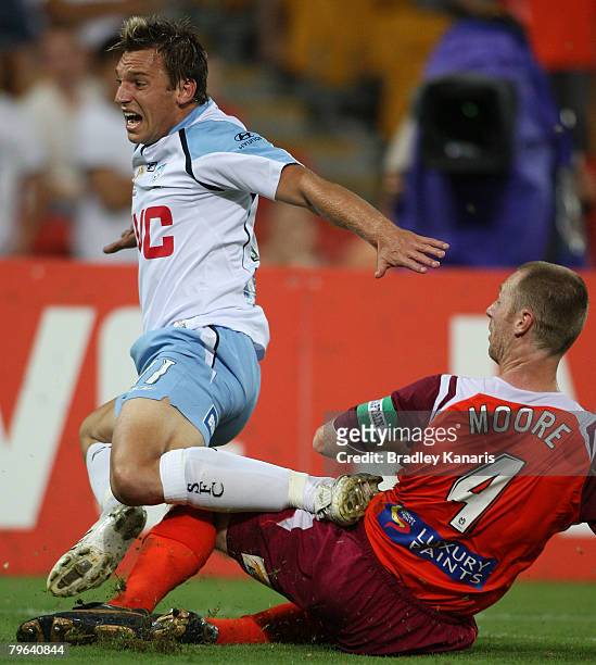 Craig Moore of the Roar tackles Robbie Middleby of Sydney during the A-League minor semi final second leg match between the Queensland Roar and...