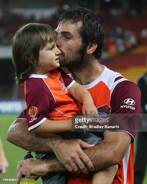Sasa Ognenovski kisses his young daughter as he celebrates victory after the A-League minor semi final second leg match between the Queensland Roar...
