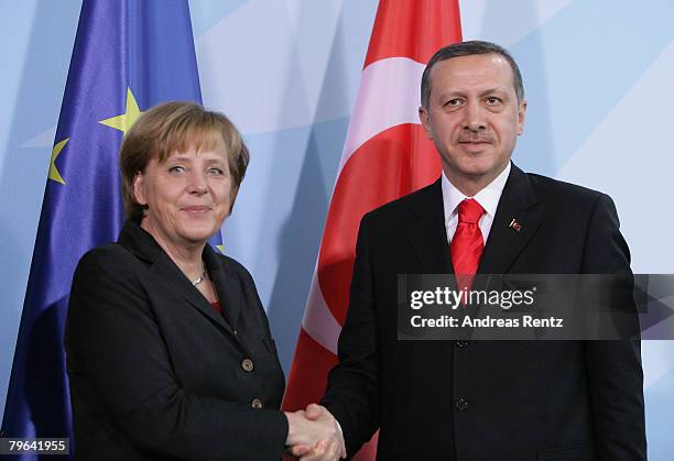 German Chancellor Angela Merkel shakes hands with Turkish Prime Minister Tayyip Erdogan during a news conference at the Chancellery on February 8,...