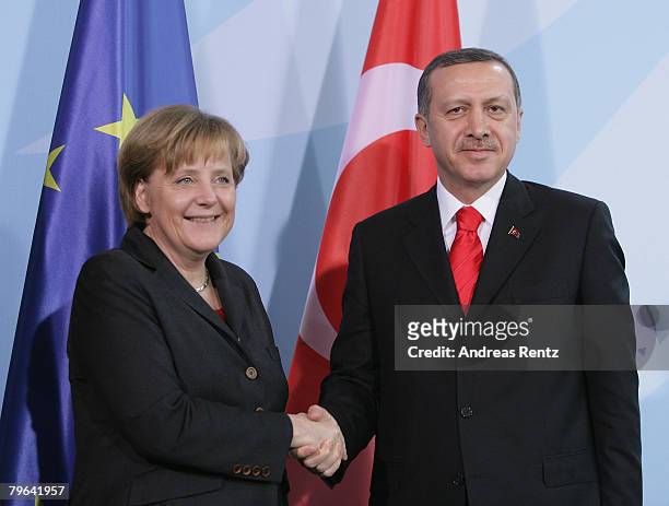 German Chancellor Angela Merkel shakes hands with Turkish Prime Minister Tayyip Erdogan during a news conference at the Chancellery on February 8,...