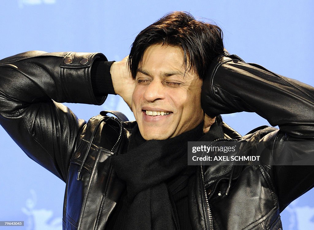 Shah Rukh Indian actor Shah Rukh Khan poses for photographers at a photocall ...
