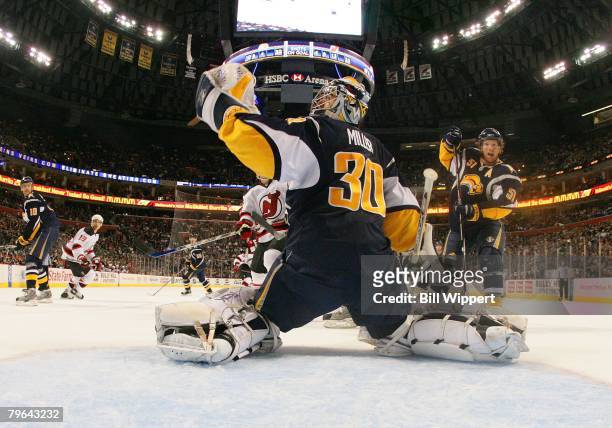 Ryan Miller of the Buffalo Sabres makes a save in front of Brian Campbell against the New Jersey Devils on February 6, 2008 at HSBC Arena in Buffalo,...