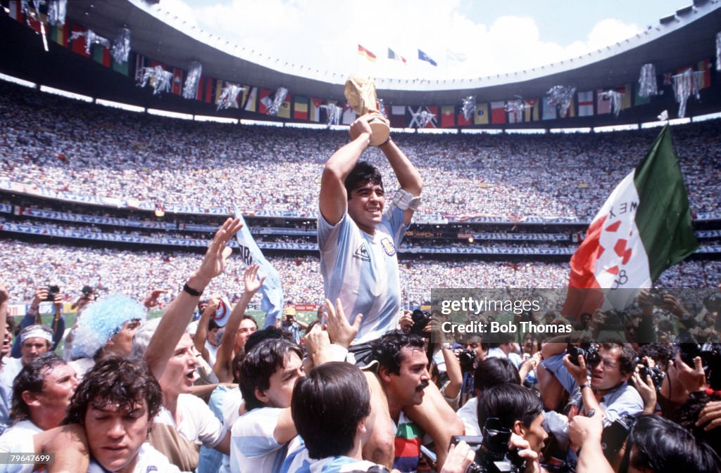 BT Sport, Football 1986 World Cup Final, Azteca Stadium, Mexico, 29th June, 1986, Argentina 3 v West Germany 2, Argentina's Diego Maradona proudly holds aloft the World Cup trophy amongst masses of fans and photographers
