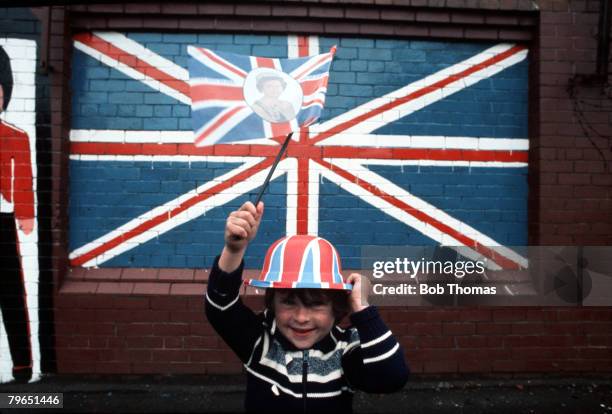 England, June 1977, A young boy is pictured wearing a Union Jack hat waving a flag to celebrate the Silver Jubilee of Queen Elizabeth II