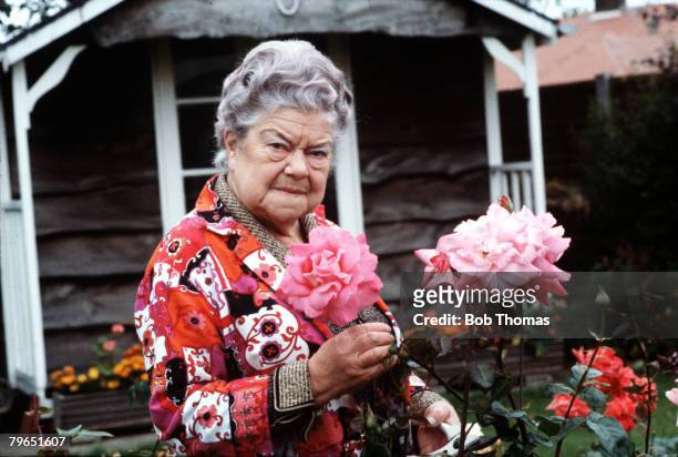 England, Circa 1970, Actress Violet Carson who plays the role of Ena Sharples in the television series "Coronation Street" is pictured in her garden...