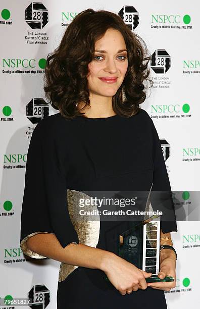Actress Marion Cotillard poses with her award for Best Actress while attending the Awards Of The London Film Critics' Circle at the Grosvenor House...