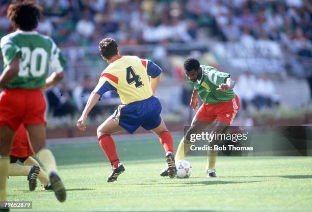 World Cup Finals, Bari, Italy, 14th June Cameroon 2 v Romania 1, Cameroon's Oman Biyick takes on Romania's Ion Andone