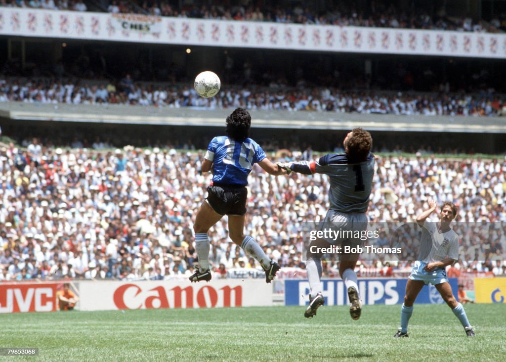 1986 World Cup Quarter Final, Azteca Stadium, Mexico, 22nd June, 1986, Argentina 2 v England 1, Argentina's Diego Maradona scores his side's first goal past English goalkeeper Peter Shilton by use of his hand, Maradona later claimed that the goal was scor