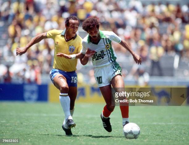 World Cup Finals, Guadalajara, Mexico, 6th June Brazil 1 v Algeria 0, Algeria's Lakhdar Belloumi under strong pressure from Brazil's Elzo