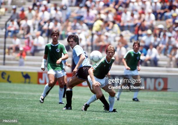 World Cup Finals, Queretaro, Mexico, 4th June 1986, West Germany 1 v Uruguay 1, West Germany's Karl-Heinz Foerster and Uruguay's De Silva keep their...