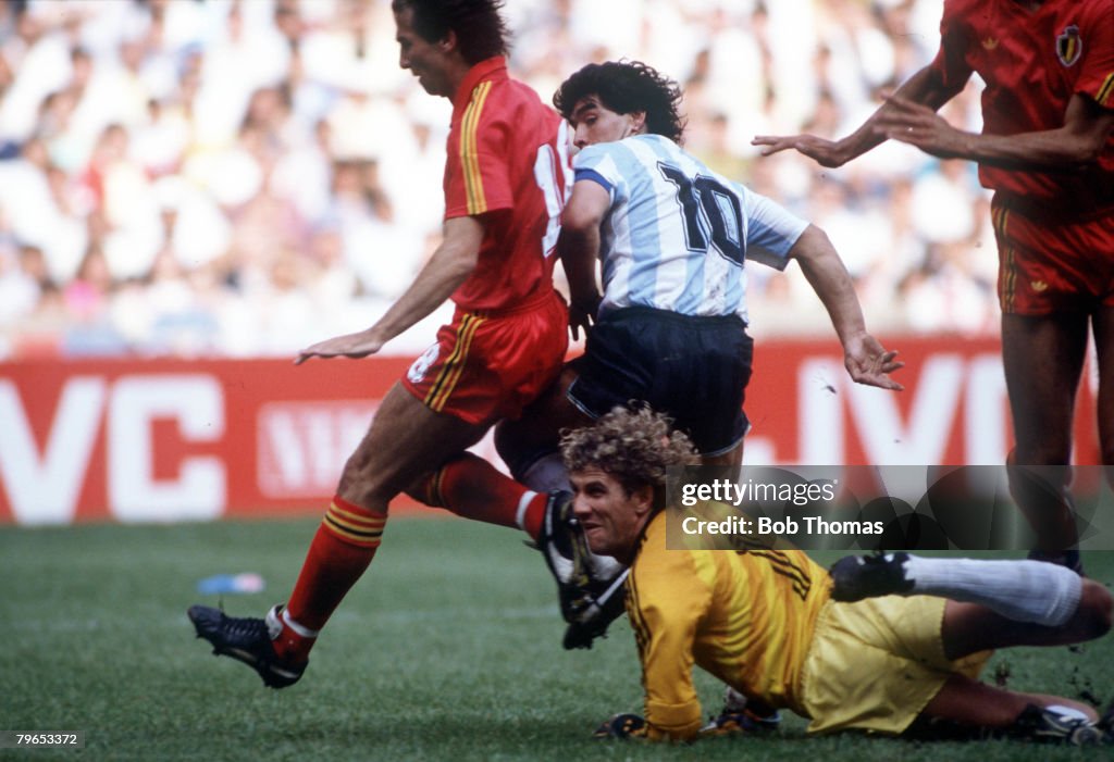 1986 World Cup Semi Final, Azteca Stadium, Mexico, 25th June, 1986, Argentina 2 v Belgium 0, Argentina's Diego Maradona beats Belgian goalkeeper Jean Marie Pfaff and defender Danny Veyt to score the first goal