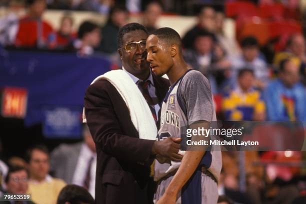 John Thompson, head coach of the Georgetown Hoyas with Alonzo Mourning talk during the Big East Basketball Tournment at Madison Square Garden on...