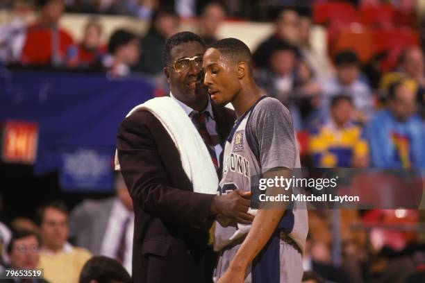 John Thompson, head coach of the Georgetown Hoyas with Alonzo Mourning talk during the Big East Basketball Tournment at Madison Square Garden on...