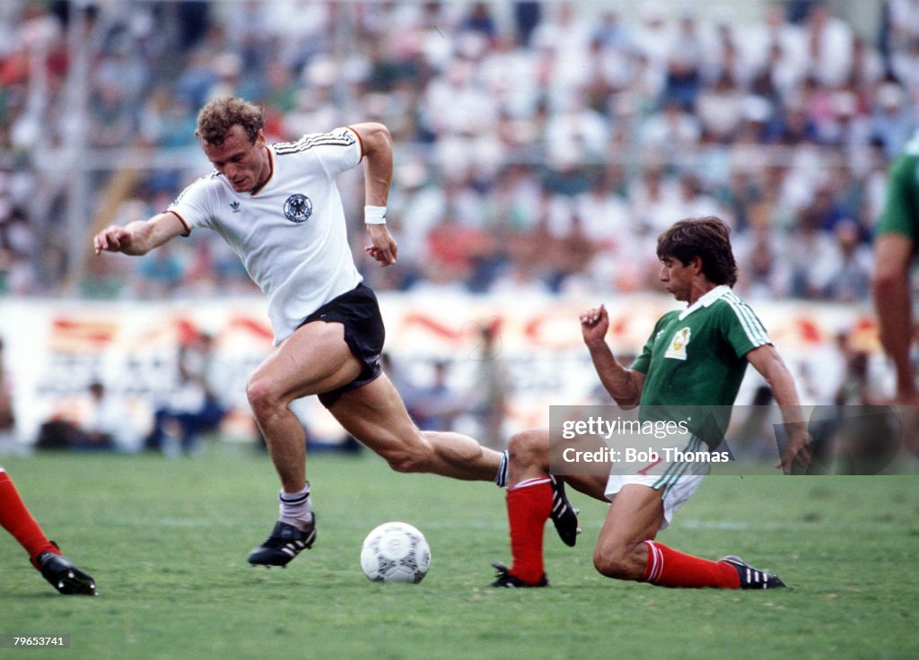 1986 World Cup Quarter Final, Monterrey, Mexico, 21st June, 1986, West Germany 0 v Mexico 0, (West Germany win 4-1 on penalties), West Germany's Hans Peter Briegel moves past Mexico's Miguel Espana with the ball