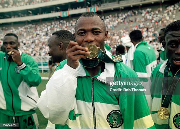 Match winner Emmanuel Amunike of the Nigeria football team kisses his gold medal after the team beat Argentina 3 - 2 in the final of the Men's...