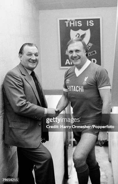 Radio reporter and 'It's a Knockout' presenter Stuart Hall shakes hands with Liverpool manager Bob Paisley in the tunnel at Anfield on December 20,...