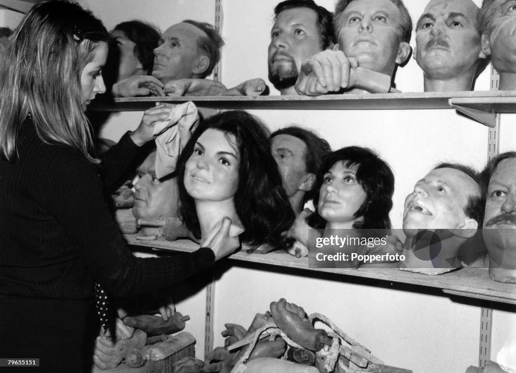 Travel, England, London, 12th February 1973, A Madame Tussaud's employee dusts down the head of Jackie Kennedy in the store room of the London waxworks with the heads of footballers George Best and Nobby Stiles prominent, Above them are politicians Jo Gri