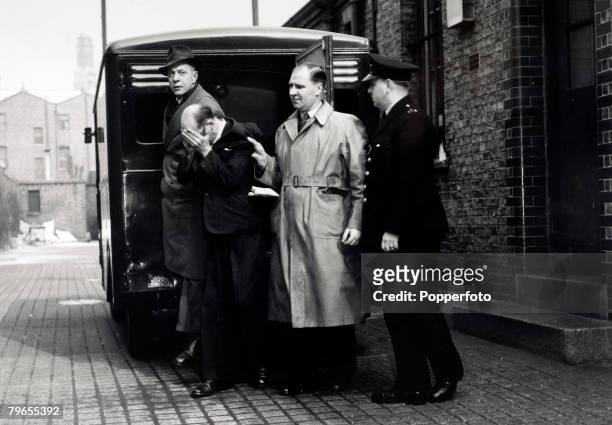 Crime, Personalities, pic: 8th April 1953, West London, John Christie, aged 55 hides his face as he is led into West London Magistrates Court to face...