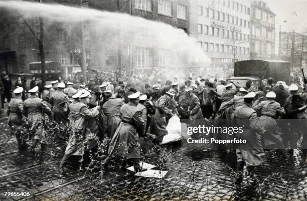 Politics, Frankfurt, Germany A water cannon assists riot police in controlling a protest by left wing students demonstrating against delivery of Axel...