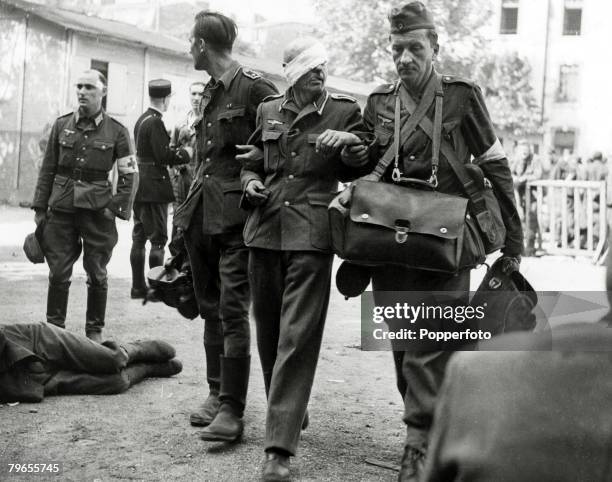 War and Conflict, World War Two, The Liberation of Paris, pic: August 1944, A wounded veteran German soldier is helped away by German Red Cross men...