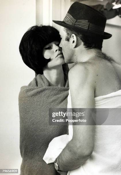 Cinema Personalities, pic: 13th July 1963, French film actress Brigitte Bardot, , pictured in a black wig playing a love scene with actor Michel...