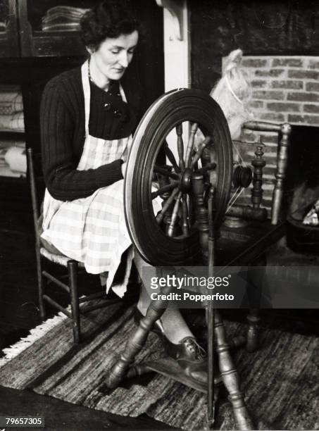 Circa 1930's, A woman a 'spinster', working at the wheel