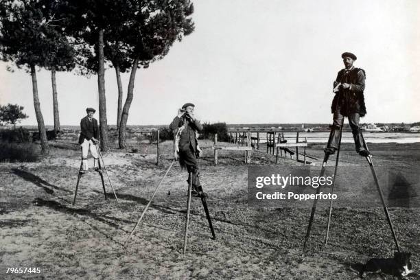 People, Oddities, pic: circa 1920's, A scene in the marsh area of Landes, near to Arcachon in Western France, where men use stilts to move across the...