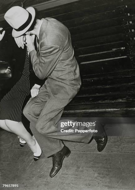 Couples, Romance, pic: circa 1940, A man "plants" a kiss on a woman, as he makes a grab for her, on a seat on the showboat "Kay Parsons" during a...