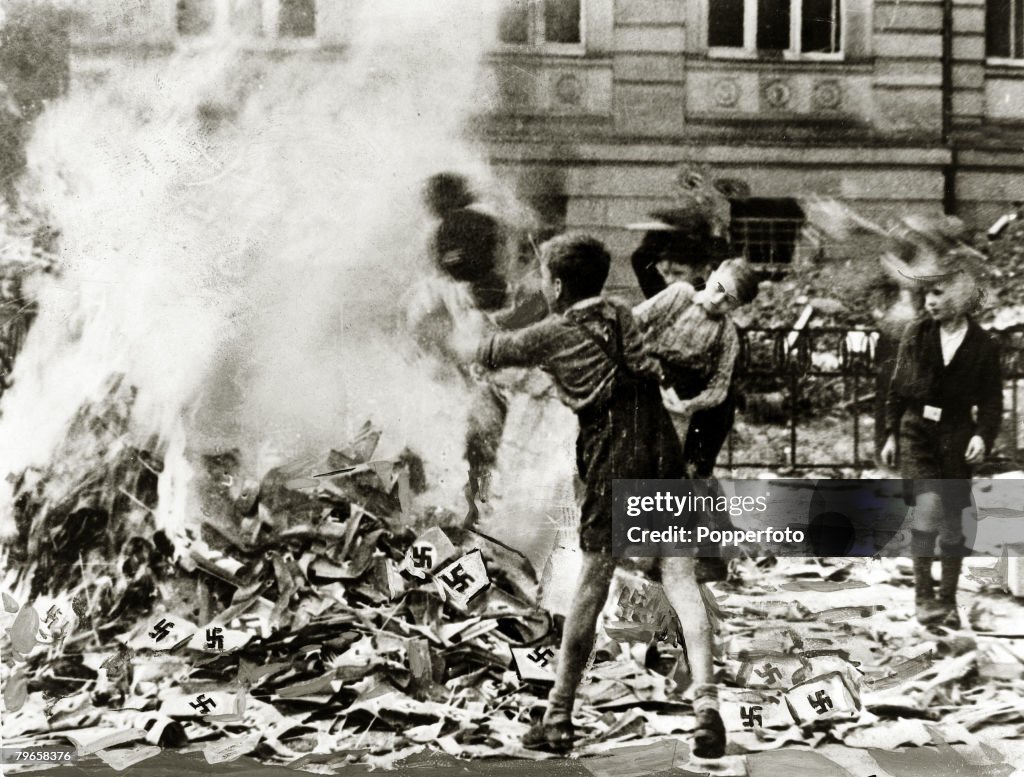 World War II, pic: circa 1945, German boys pictured burning Nazi books and swastikas in Cologne