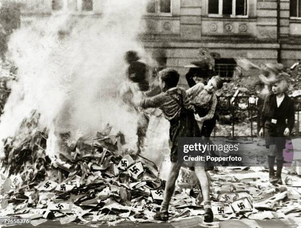 Circa 1945, German boys pictured burning Nazi books and swastikas in Cologne