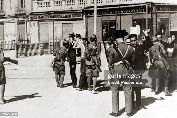 War and Conflict, Spain, Unrest, pic: 1934, Civil Guards holding up demonstrators suspected of carrying weapons in Madrid, With what started as a...