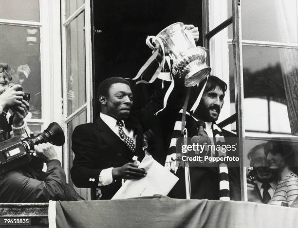 17th May 1981, Tottenham Hotspur's Garth Crooks, left, and Ricky Villa display the F,A, Cup to crowds at Tottenhm Town Hall the day after beating...