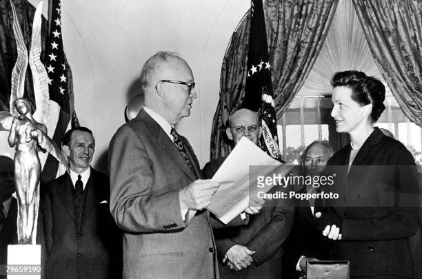 Washington DC, USA, 10th November 1953, Dwight Eisenhower, President of the United States, reads the Aviation Achievement Award to Madame Jacqueline...