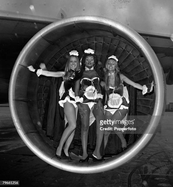 London, England, 2nd February 1972, Three Penthouse "pets" pose inside a Jumbo Jet engine prior to leaving London airport for the USA