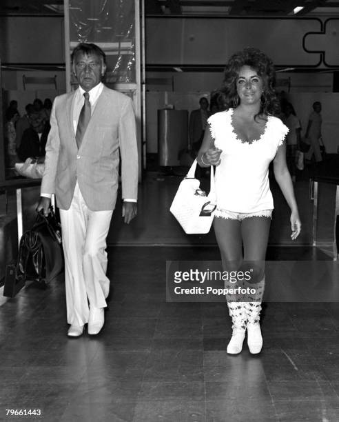 London, England, 29th July 1971, Film actress Elizabeth Taylor is pictured leaving Heathrow for a Mediterranean holiday with husband Richard Burton ,...