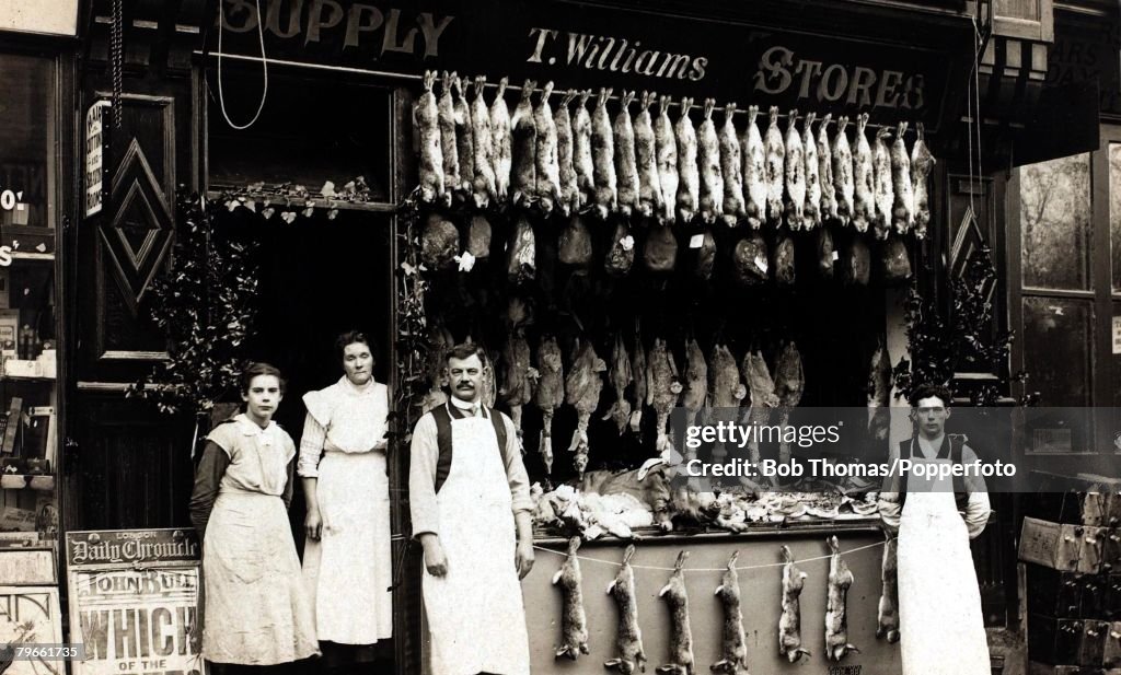 Social History/Shopkeepers, A butcher's shop with staff outside, supplying also rabbit and game in large display, Great Britain, circa 1920