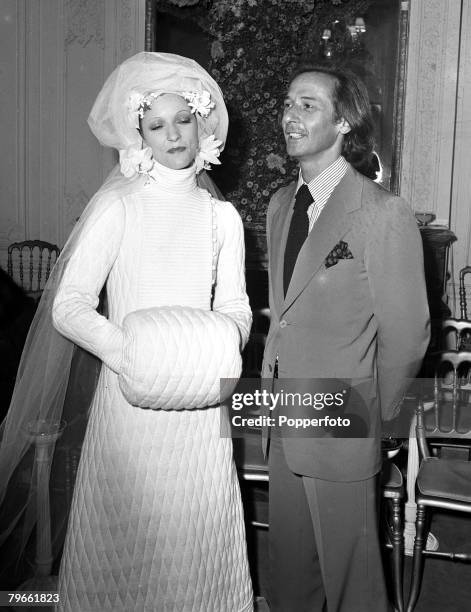 Paris, France, 23rd July 1970, French fashion designer Marc Bohan has a look at his wedding dress created for the House of Dior, modelled at their...