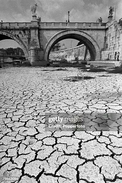 Rome, Italy, 23rd August 1971, A picture of the parched bed of the River Tiber by the Bridge of Angels, with the Dome of St Peter's Cathedral framed under the arch (right) Rome, Italy, 23rd August 1971, A picture of the parched bed of the River Tiber by the Bridge of Angels, with the Dome of St Peter's Cathedral framed under the arch (right)