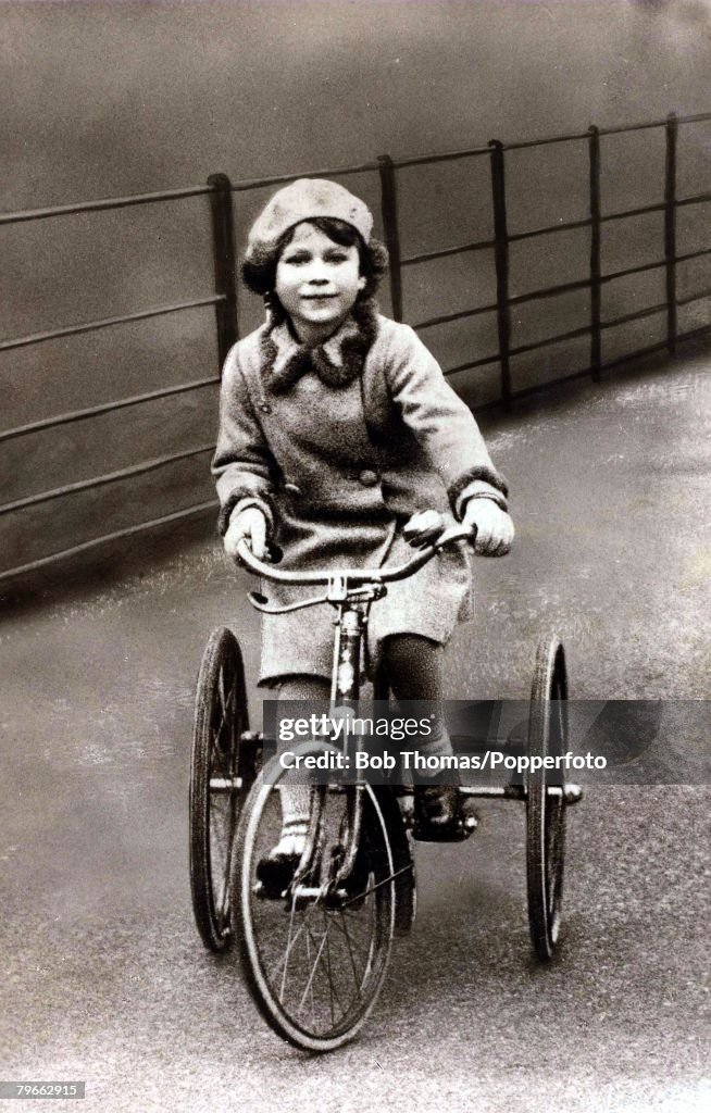 British Royalty, The young Princess Elizabeth (Queen Elizabeth II) is pictured riding on her tricycle, Circa 1930