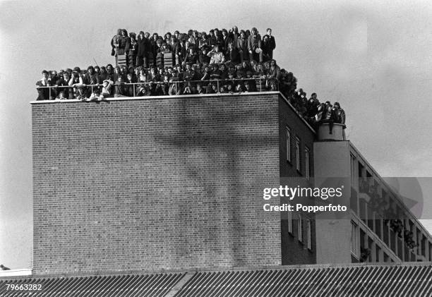 Sport, Football, London, England, 14th February 1972, Fans crowd the roof of a block of flats overlooking West Ham's Upton Park pitch as the Hammers...