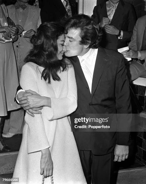 London, England, 7th August 1970, British actor Albert Finney kisses his French actress wife Anouk Aimee after their registry office wedding ceremony