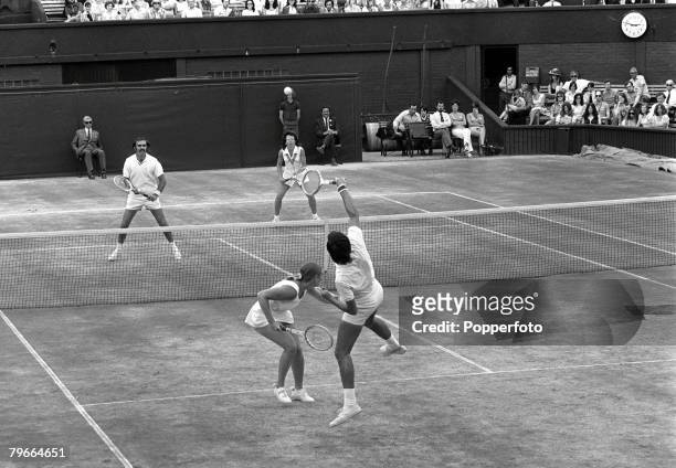 All England Lawn Tennis Championships, Wimbledon, Mixed Doubles Final, 8th July 1973, Raul Ramirez of Mexico leaps up to play a shot watched by...