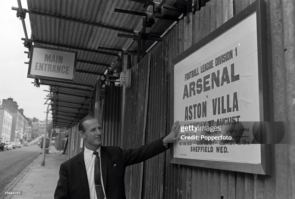Football, London, England, 25th August 1966, Arsenal manager Bertie Mee pictured outside Highbury Stadium looking at the fixture for the upcoming league match with Aston Villa