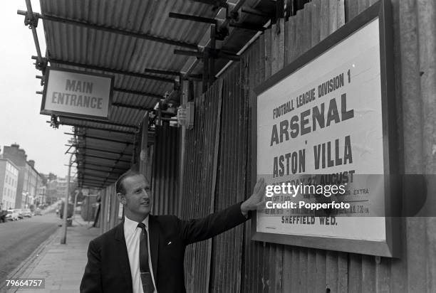 Football, London, England, 25th August 1966, Arsenal manager Bertie Mee pictured outside Highbury Stadium looking at the fixture for the upcoming...