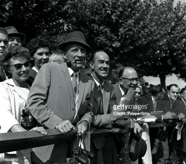 Esher, Surrey, England, 11th September 1961, American film actor Bing Crosby smoking a pipe as he enjoys a day out at the races at Sandown Park,...
