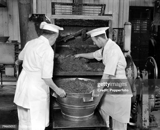 October 1947, Bakers pour the mixture for Princess Elizabeth's wedding cake at a Berkshire factory