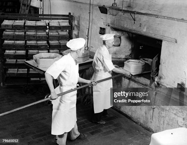 October 1947, Bakers sliding Princess Elizabeth's wedding cake into the oven's at a Berkshire confectionery factory